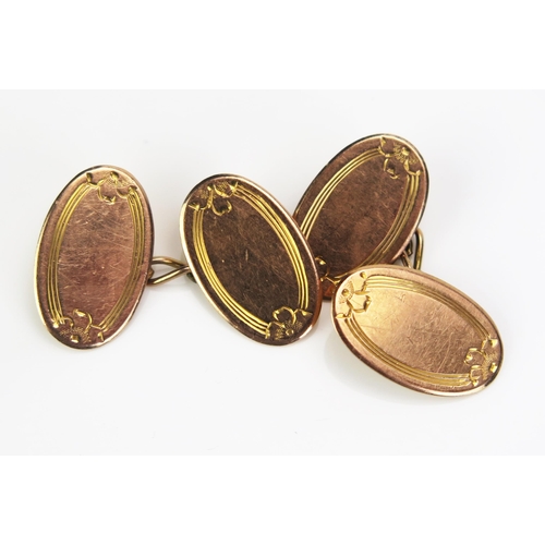 127 - An Antique Pair of 9ct Gold Cufflinks of oval shape with chased decoration, Birmingham 1919, 4.44g