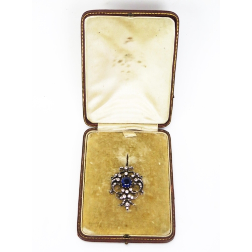 135 - An Antique Sapphire and Diamond Brooch with hinged pendant mount, the 9x8.8mm claw set deep blue sap... 