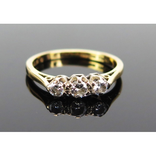 139 - An 18ct Gold and Diamond Three Stone Ring, central stone c. 3.5mm and shouldered by .3mm stones, hal... 