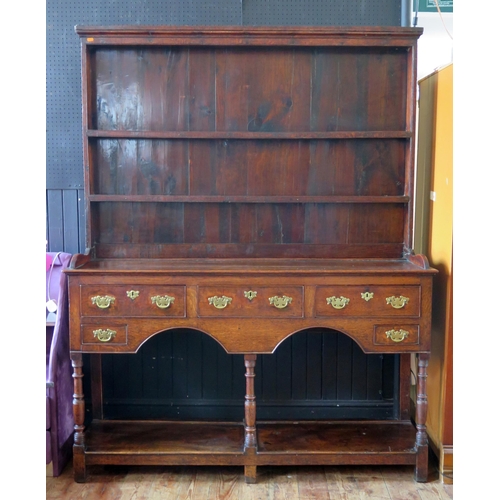 1410 - A mid 18th century oak dresser, the associated shelved superstructure with moulded cornice, the base... 