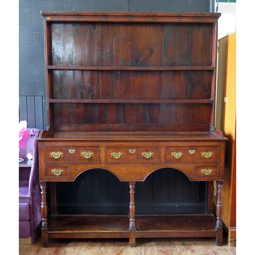 1410 - A mid 18th century oak dresser, the associated shelved superstructure with moulded cornice, the base... 