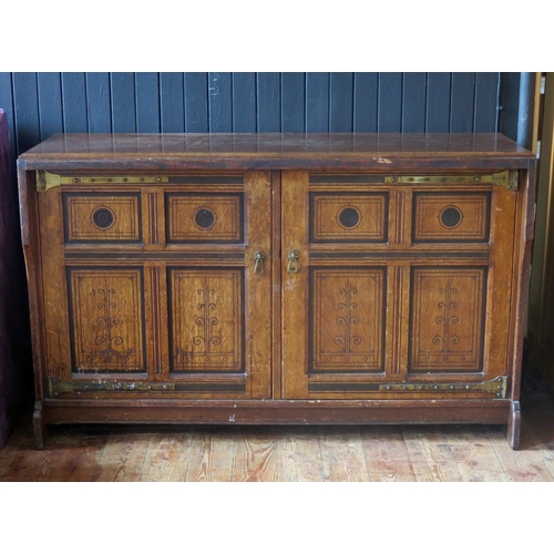 1411 - An aesthetic movement period oak side cupboard, the rectangular top with a moulded edge, above a pai... 