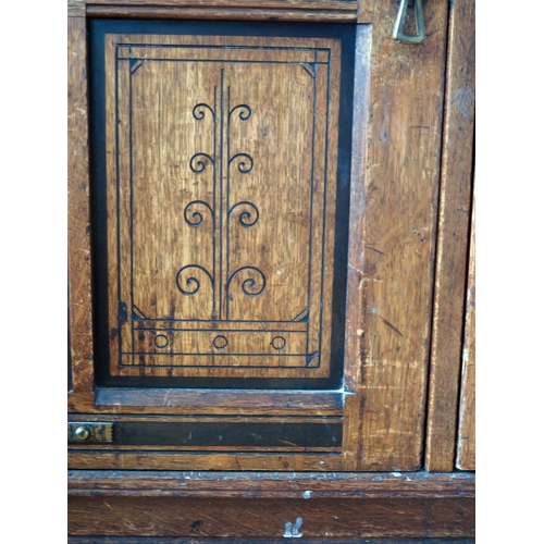 1411 - An aesthetic movement period oak side cupboard, the rectangular top with a moulded edge, above a pai... 