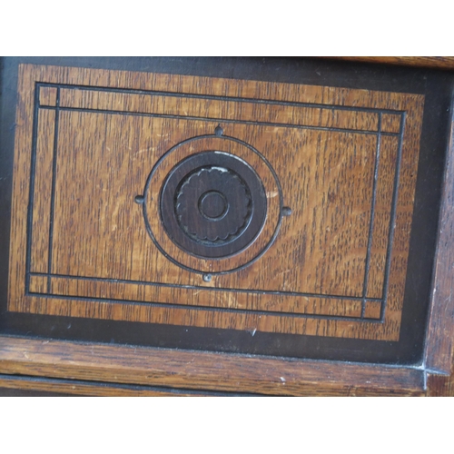 1411 - An aesthetic movement period oak side cupboard, the rectangular top with a moulded edge, above a pai... 