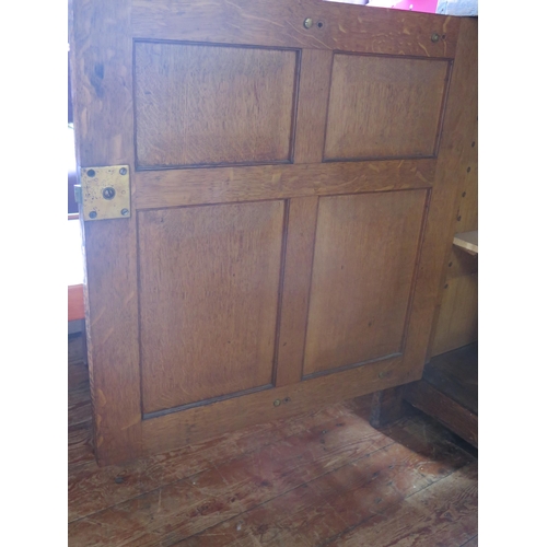 1411 - An aesthetic movement period oak side cupboard, the rectangular top with a moulded edge, above a pai... 