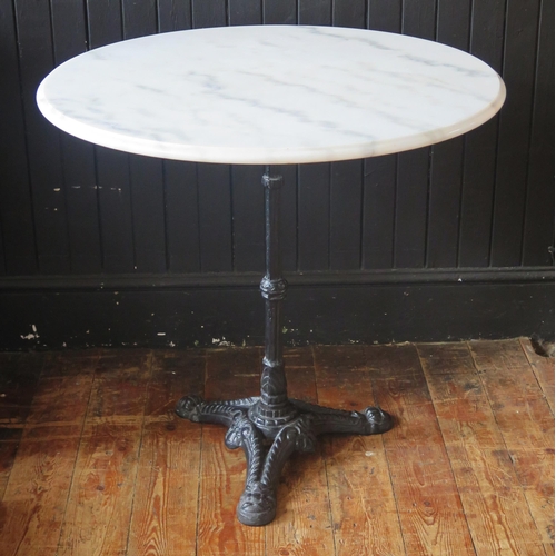 1423 - A marble topped Bistro or conservatory table, the circular top on a cast iron stem and tripod base, ... 