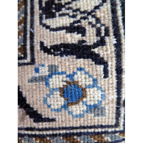 1435 - A Nain rug, the ivory field with powder blue cartouche and central pole medallion, ivory floral span... 