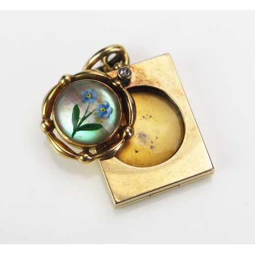 155 - An Antique Forget-Me-Not Crystal Metamorphic Pendant Locket set with a rose cut diamond, in a precio... 