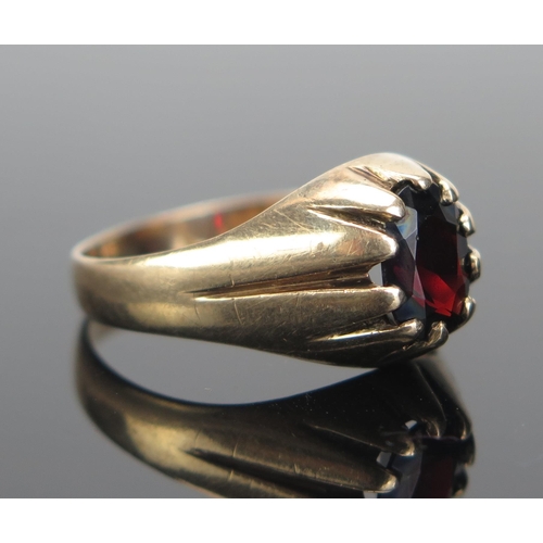 159 - A Gent's 9ct Gold and Garnet Ring, c. 9x7.5mm stone, hallmarked, size V.5, 4.25g