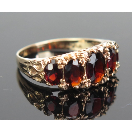 162 - A 9ct Gold and Garnet Five Stone Ring, 7x5.5mm central stone, hallmarked, size Q, 2.97g