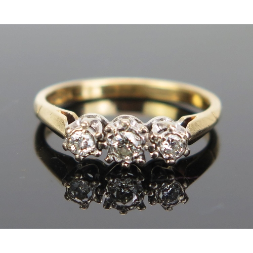 164 - An 18ct Gold Three Stone Diamond Ring, the central 3mm flanked by two 2.3mm brilliant round cuts, ha... 