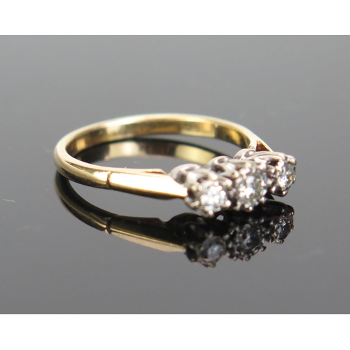 164 - An 18ct Gold Three Stone Diamond Ring, the central 3mm flanked by two 2.3mm brilliant round cuts, ha... 