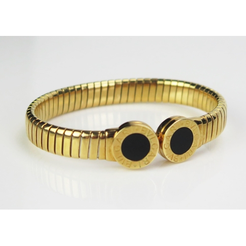 190 - A BVLGARI Tubogas 18ct Gold and Onyx Torque Bangle , full marks, steel spring core, 35.65g