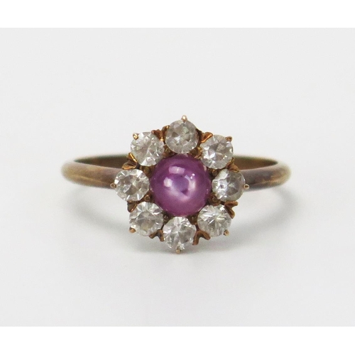 195 - A Star Ruby and White Sapphire Star Ring in an unmarked precious yellow metal setting, 11mm head, KE... 