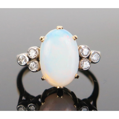 196 - An 18ct Gold, Opal and Diamond Ring, 12.5x8.5mm central stone flanked by three c, .2mm diamonds in r... 