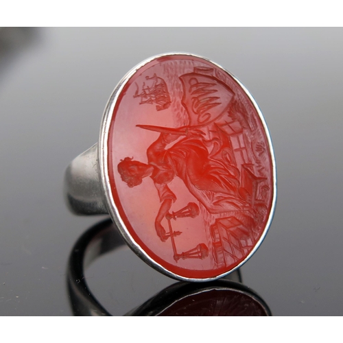 202 - A Large Carnelian Seal Ring in an unmarked precious white metal mount, the 28x21.5mm matrix profusel... 