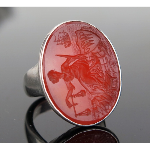 202 - A Large Carnelian Seal Ring in an unmarked precious white metal mount, the 28x21.5mm matrix profusel... 