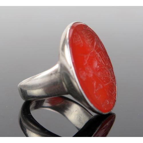 202 - A Large Carnelian Seal Ring in an unmarked precious white metal mount, the 28x21.5mm matrix profusel... 