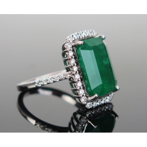 216 - A Modern 18K White Gold, Emerald and Diamond Ring, the central 10.53ct 14x11x6.7mm stone with c. 1.8... 