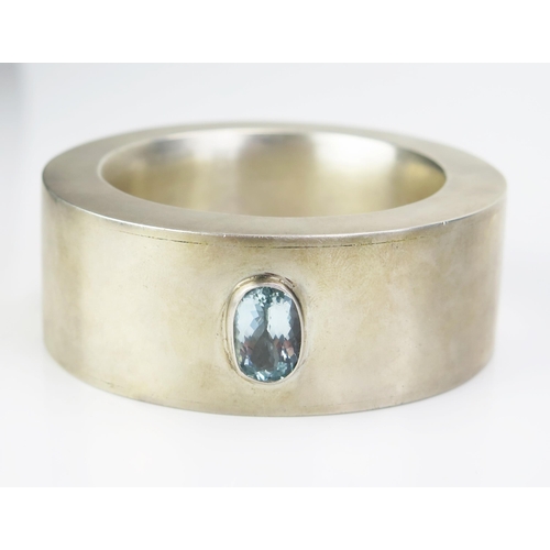 221 - A Modern Diamond, Aqua Marine and Gem Set Bangle in a white and yellow metal setting, 65mm inner dia... 