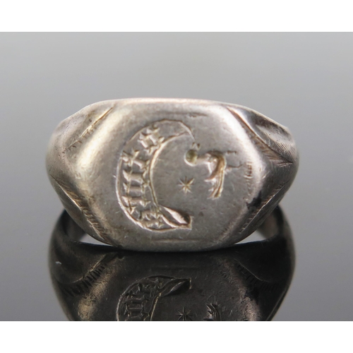 222 - An Antique White Metal Seal Ring, the 15.5mm wide head engraved with a bird with a star over and cre... 