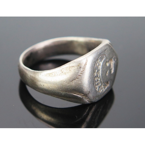 222 - An Antique White Metal Seal Ring, the 15.5mm wide head engraved with a bird with a star over and cre... 