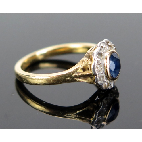 228 - A Sapphire and Diamond Cluster Ring in a precious yellow and white metal setting, size H.25, 3.17g. ... 