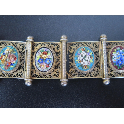 263 - A Floral Micromosaic Eight Panel Bracelet in an unmarked silver gilt filigree setting, 28mm wide, 6.... 