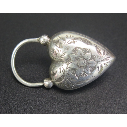 266 - A Victorian Unmarked Silver Heart Pendant with inset green stone cabochon and chased foliate decorat... 