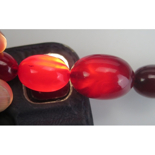 274 - A Faux Cherry Amber Graduated Bead Necklace, 29