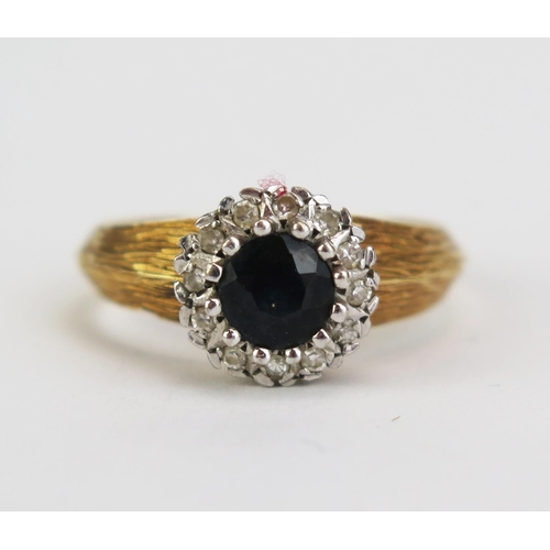 412 - An 18ct Gold, Sapphire and Diamond Cluster Ring, c. 5.4mm central stone, 9.5mm head, size N, hallmar... 