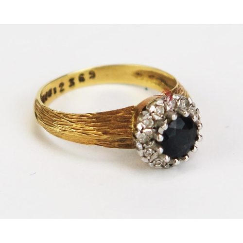 412 - An 18ct Gold, Sapphire and Diamond Cluster Ring, c. 5.4mm central stone, 9.5mm head, size N, hallmar... 