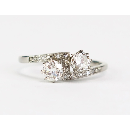 415A - A Platinum and Diamond Crossover Ring set with two c. 4.3mm principal stones, stamped PLAT, size N, ... 