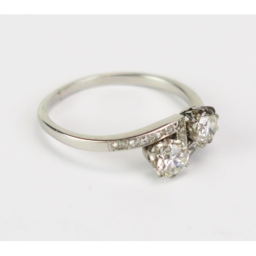415A - A Platinum and Diamond Crossover Ring set with two c. 4.3mm principal stones, stamped PLAT, size N, ... 