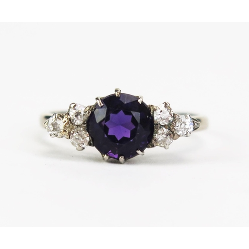 416A - An Amethyst and Diamond Seven Stone Ring in a precious white metal setting, c. 7.9mm principal stone... 