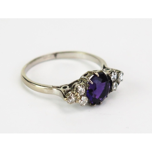 416A - An Amethyst and Diamond Seven Stone Ring in a precious white metal setting, c. 7.9mm principal stone... 