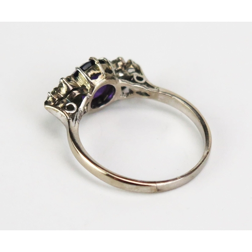 416A - An Amethyst and Diamond Seven Stone Ring in a precious white metal setting, c. 7.9mm principal stone... 