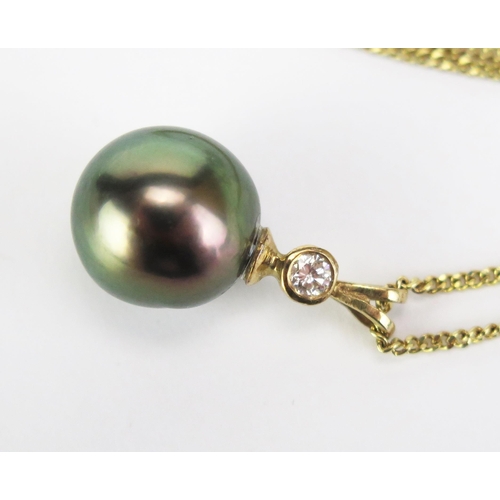 422 - A 9ct Gold, untested South Sea Pearl and Diamond Pendant, 23mm drop, hallmarked, on a 9ct gold chain... 