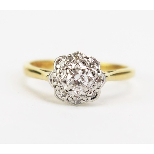 423 - An 18ct Gold and Diamond Cluster Ring, 8.5mm platinum head, hallmarked, size K.5, 2.83g