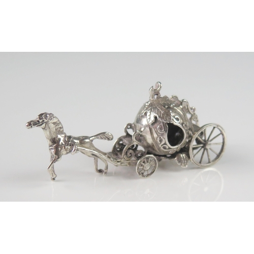 506 - A miniature silver model of a coach, unmarked, with melon-shaped coachworks drawn by a single horse,... 