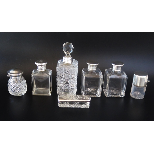 704 - A collection of clear glass and silver mounted dressing table jars and bottles, various makers and d... 