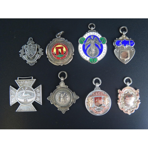 709 - Seven assorted silver sporting medallions/fobs, together with another fob, (8).