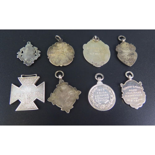 709 - Seven assorted silver sporting medallions/fobs, together with another fob, (8).