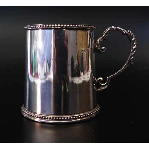 716 - A QEII Silver Christening Mug, 7cm high, Birmingham 1992, W I Broadway & Co., 100.8g