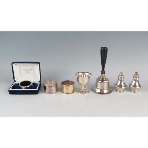 733 - A QEII Silver Table Bell (Birmingham 1990, W I Broadway & Co.), pair of silver cruets, two napkin ri... 