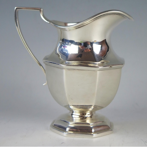 757 - A George V silver pedestal cream jug, maker Thomas Bradbury & Sons Ltd, London, 1927, of octagonal f... 