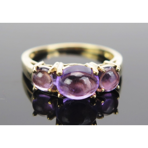 82 - A 9ct Gold and Cabochon Amethyst Dress Ring, 17x6mm head, hallmarked, size N.25, 2.79g