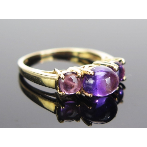 82 - A 9ct Gold and Cabochon Amethyst Dress Ring, 17x6mm head, hallmarked, size N.25, 2.79g