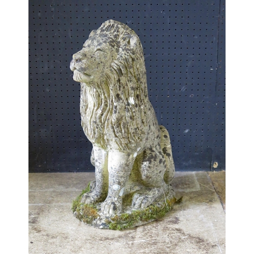 1363 - A reconstituted stone figure of a semi-recumbent lion, mounted on an oval base, 55cm high.