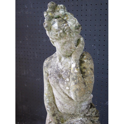 1364 - A reconstituted stone statue of a semi-naked female draped in robes and raised on a socle base, 68cm... 